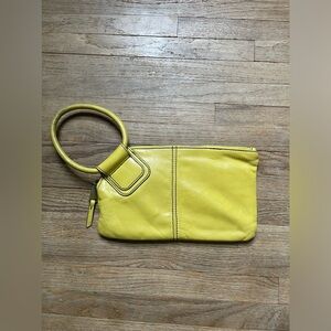 HOBO wristlet: clutch with a circular handle.